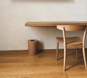 Table et chaise en bois, design épuré, sur un sol en bois, créant une ambiance chaleureuse et contemporaine.
